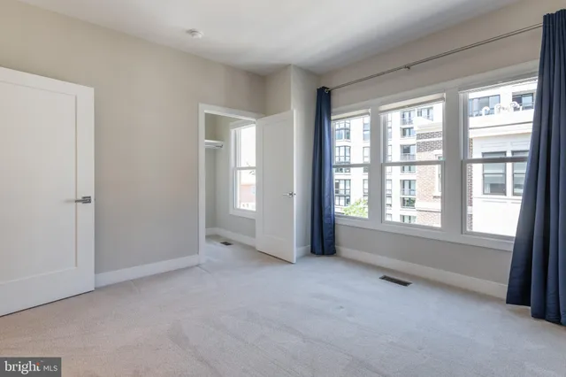 a view of a patio with couches table and chairs with plants and trees
