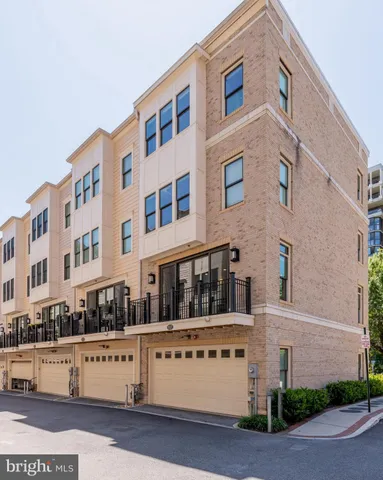 a front view of a building with a garden