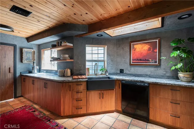 a kitchen with stainless steel appliances granite countertop a stove refrigerator and a microwave oven