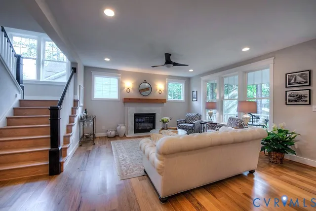 a living room with fireplace furniture and a wooden floor