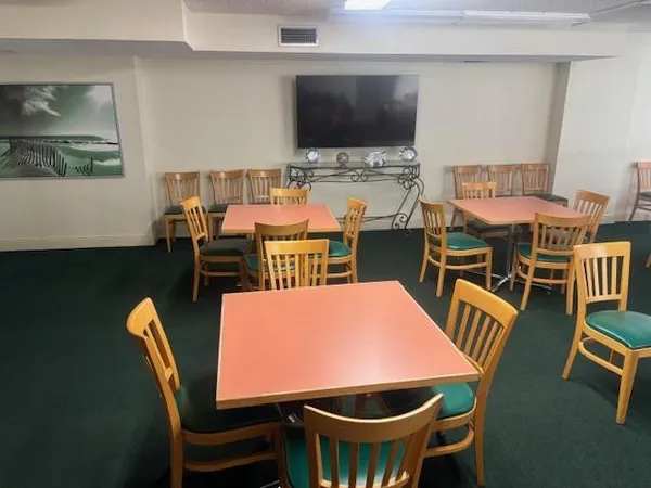 a view of a patio with table and chairs