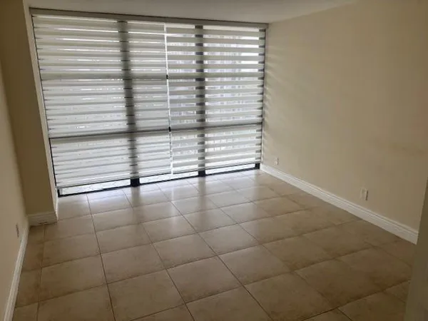 a room with pool table and windows
