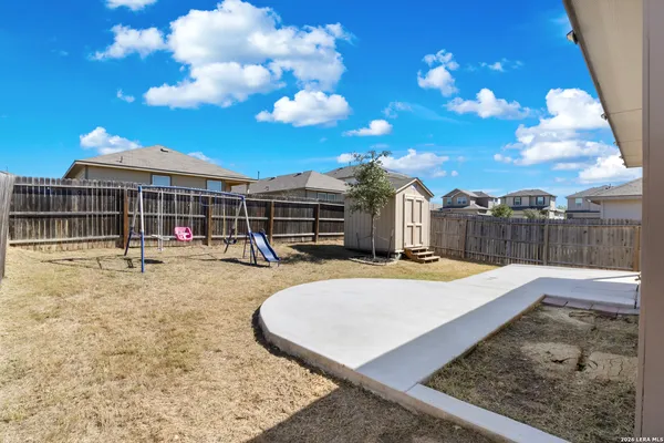 a view of a house with a backyard and sitting area