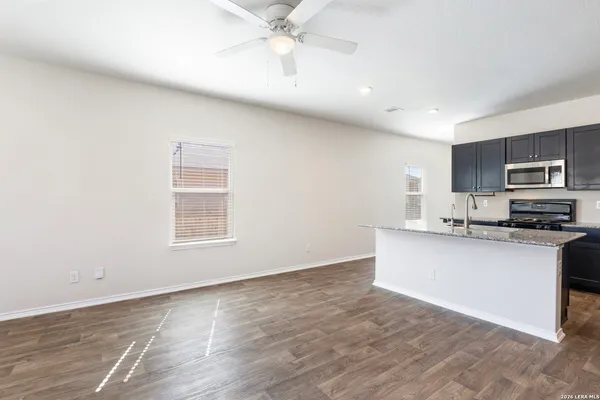 a kitchen with stainless steel appliances a microwave a stove a sink and a microwave