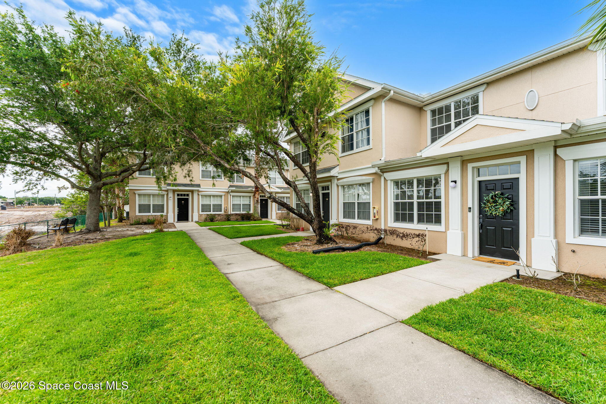 110 Turpial Way, Unit 106 Melbourne, FL 32901 - Photo 47 of 50 front view of a house and a yard