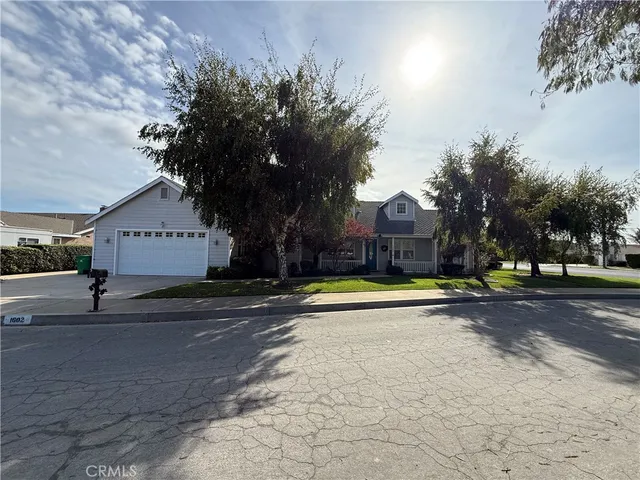 a view of swimming pool with sitting area and trees in the background