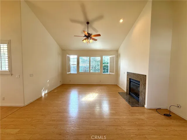a view of an empty room with a fireplace and a window