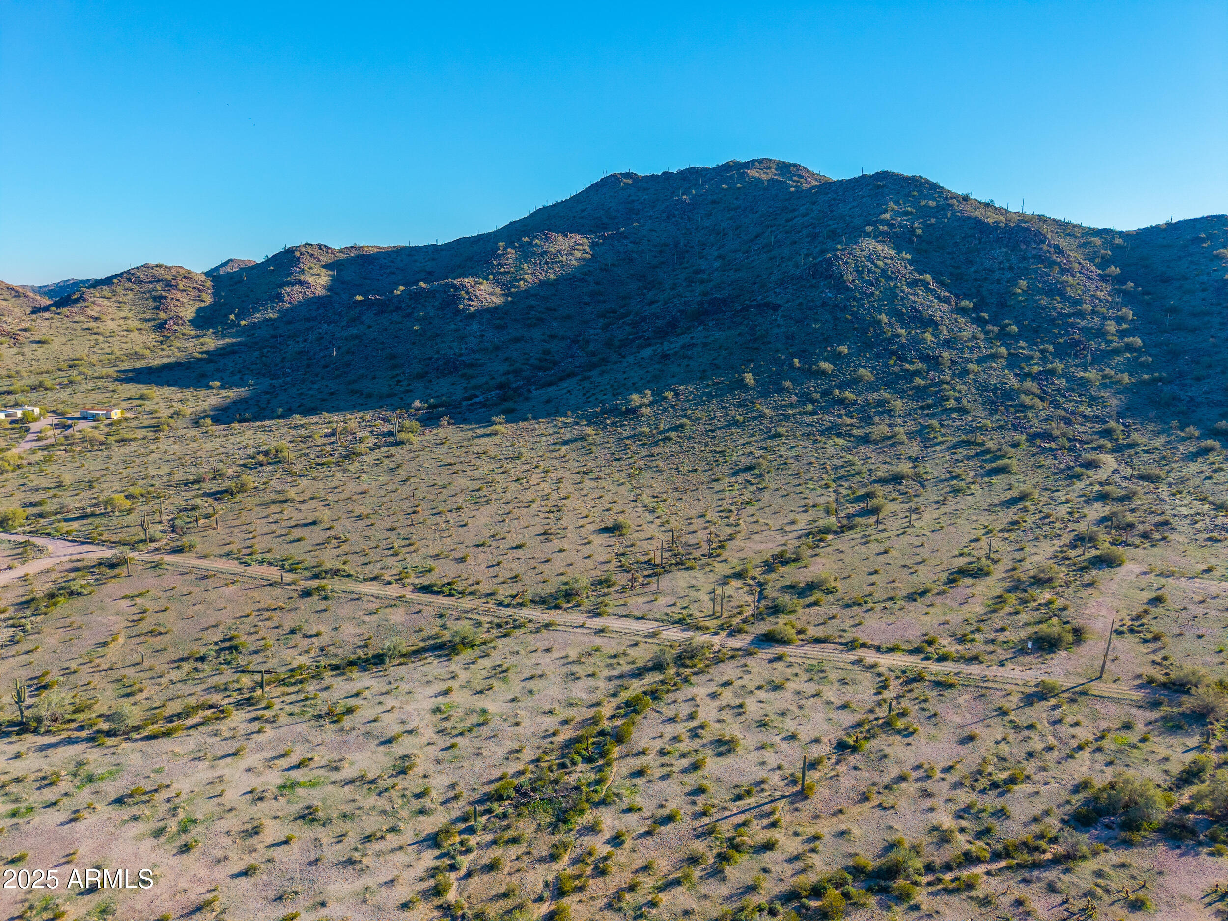 0 West Lantern Road Maricopa, AZ 85139 - Photo 7 of 21 a view of a dry field with mountains in the background