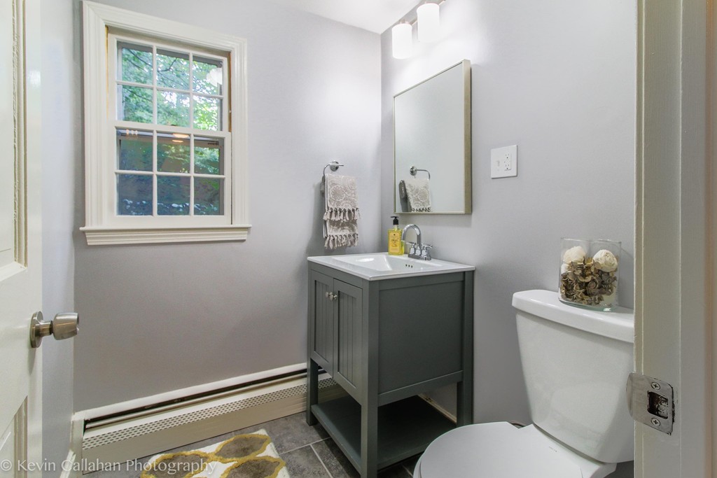 14 Pine Hill Road Framingham, MA 01701 - Photo 15 of 26 a bathroom with a toilet sink and mirror