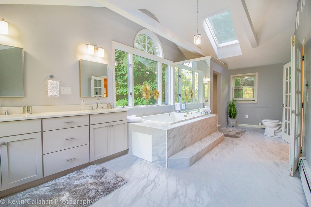 14 Pine Hill Road Framingham, MA 01701 - Photo 17 of 26 a large white bathroom with a large tub and sink
