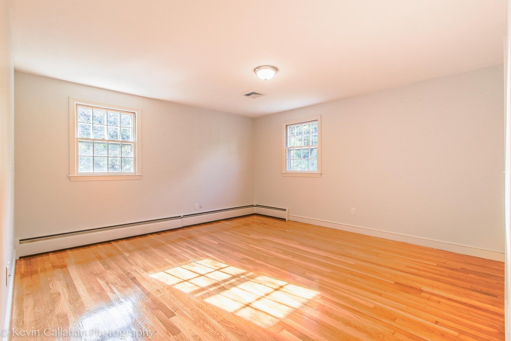 14 Pine Hill Road Framingham, MA 01701 - Photo 18 of 26 a view of an empty room with wooden floor and a window