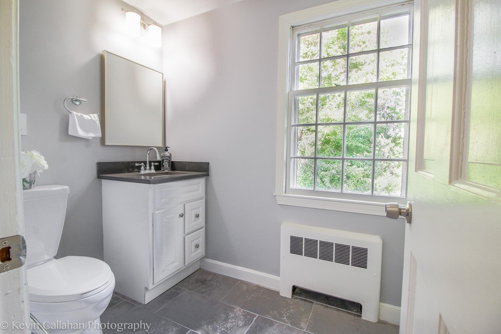 14 Pine Hill Road Framingham, MA 01701 - Photo 20 of 26 a bathroom with a toilet sink and mirror