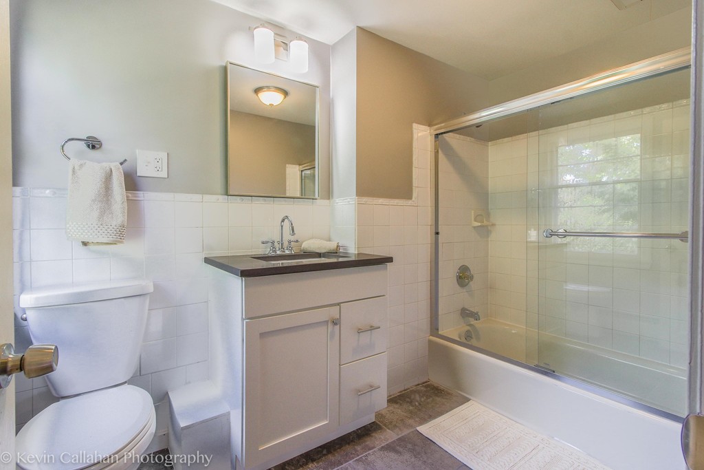 14 Pine Hill Road Framingham, MA 01701 - Photo 22 of 26 a bathroom with a granite countertop sink toilet a mirror and shower