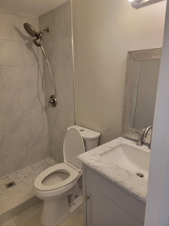 2100 Diana Drive, Unit 107 Hallandale Beach, FL 33009 - Photo 6 of 9 a bathroom with a granite countertop toilet and a sink