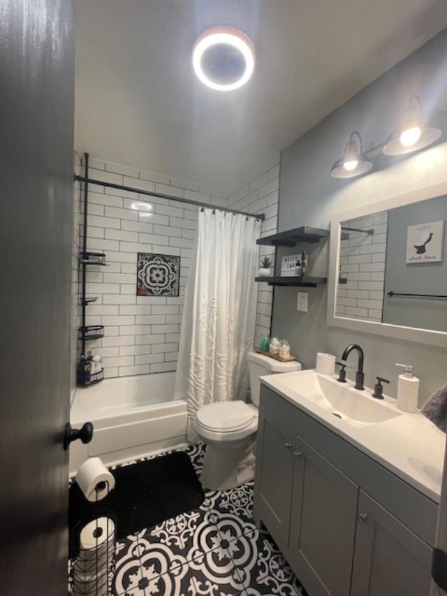 5611 16th Place Lubbock, TX 79416 - Photo 13 of 17 a bathroom with a sink toilet and shower