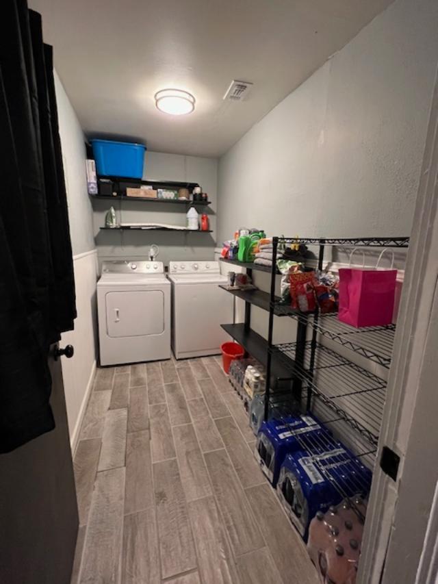 5611 16th Place Lubbock, TX 79416 - Photo 9 of 17 a view of washer and dryer with bathroom in the background