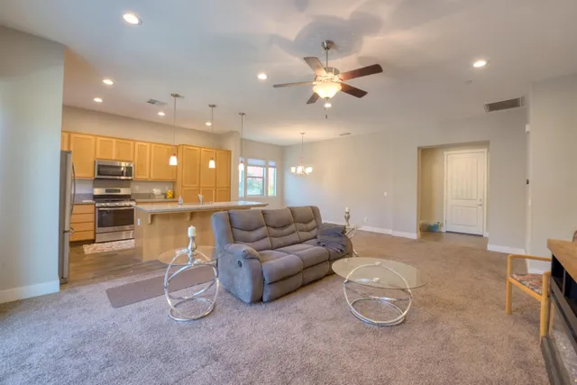 a living room with furniture and kitchen view