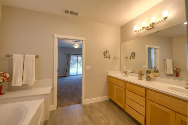 a bathroom with a sink a vanity and a mirror