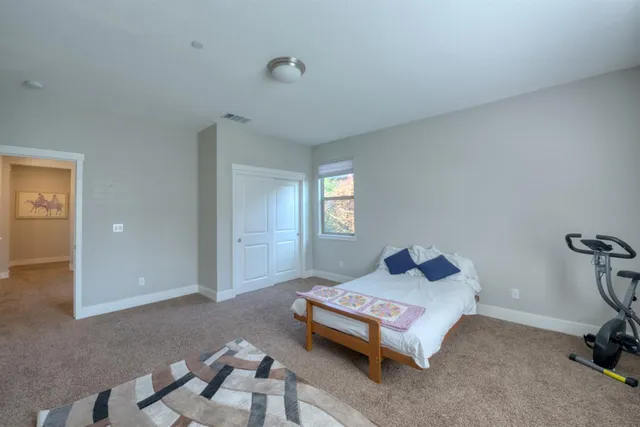 a bedroom with a bed and window