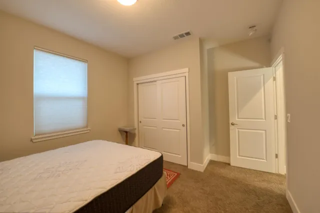 a bedroom with a bed and a window