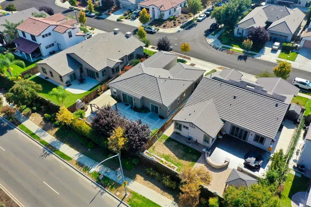 an aerial view of a house with a garden and swimming pool