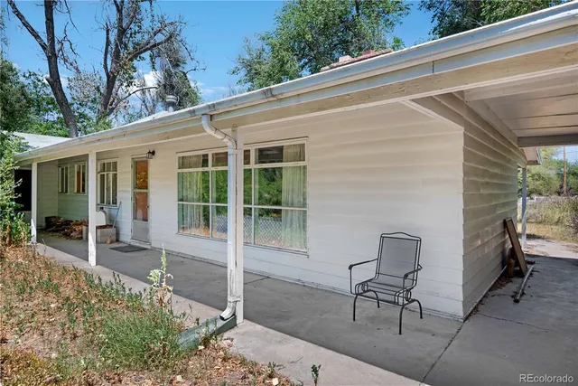 a view of a patio with table and chairs next to a yard