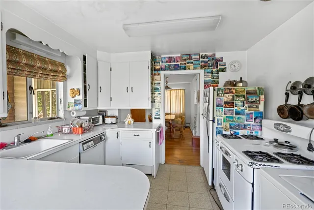 a living room with a table chairs and a chandelier