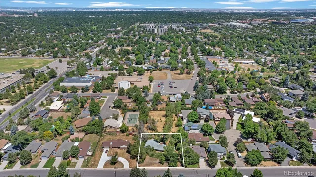 an aerial view of residential houses with outdoor space and ocean view