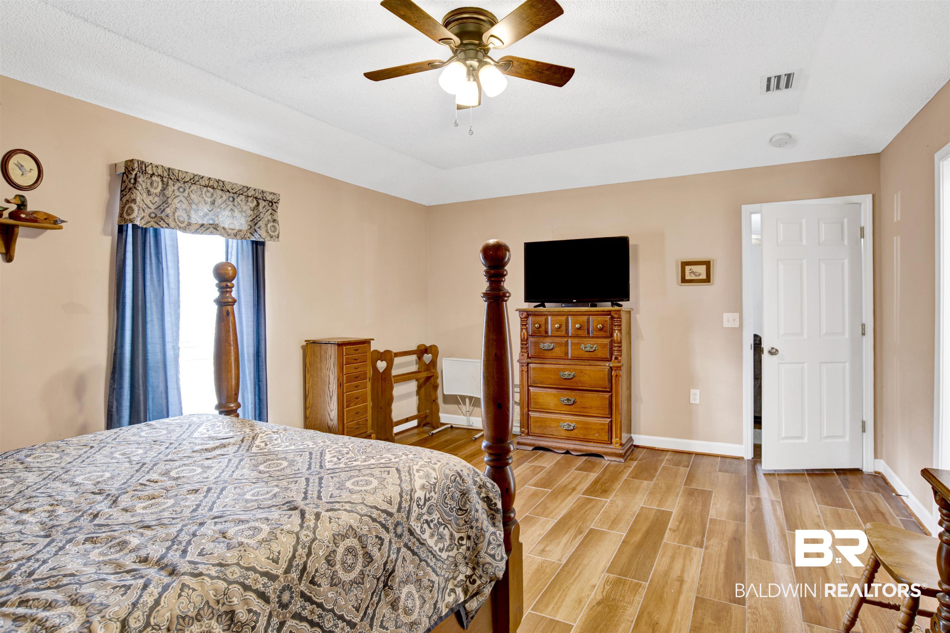 36434 Alexandria Trail Stapleton, AL 36578 - Photo 8 of 27 Bedroom with wood tiled floors and ceiling fan
