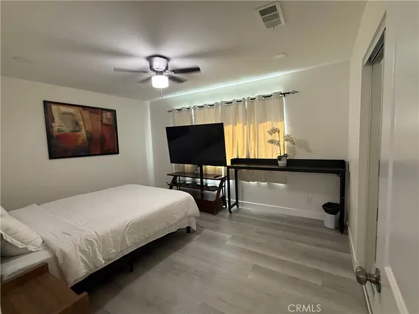 a bedroom with a bed and a flat screen tv