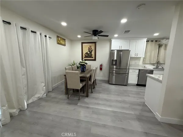 a view of kitchen with refrigerator microwave and wooden floor
