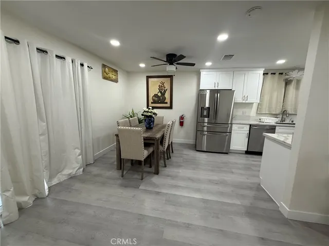 a view of kitchen with refrigerator microwave and wooden floor