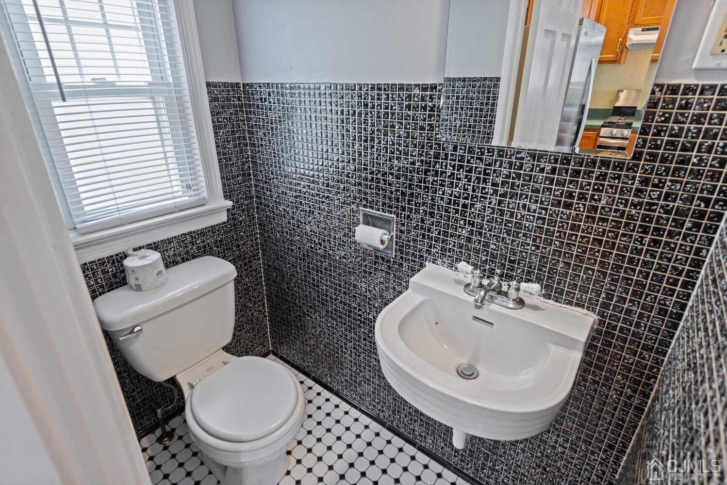 210 Rector Street Perth Amboy, NJ 08861 - Photo 12 of 24 a bathroom with a toilet and a sink