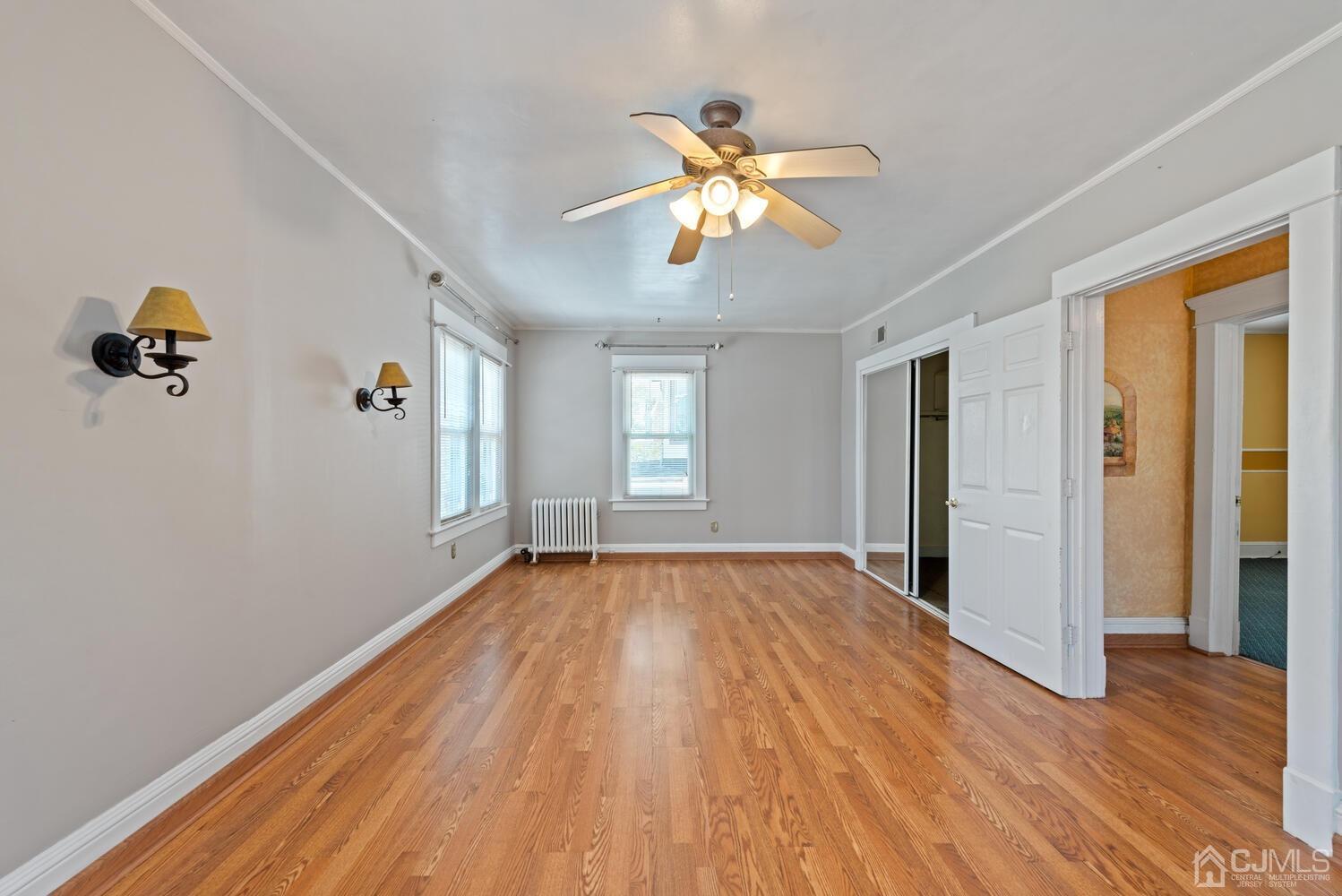 210 Rector Street Perth Amboy, NJ 08861 - Photo 15 of 24 a view of an empty room with wooden floor and window