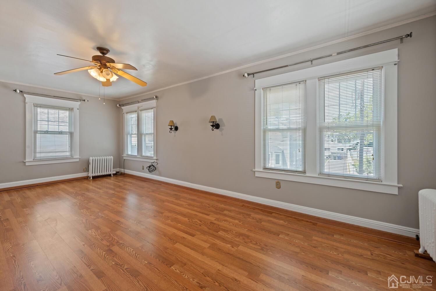 210 Rector Street Perth Amboy, NJ 08861 - Photo 16 of 24 a view of an empty room with a window and wooden floor