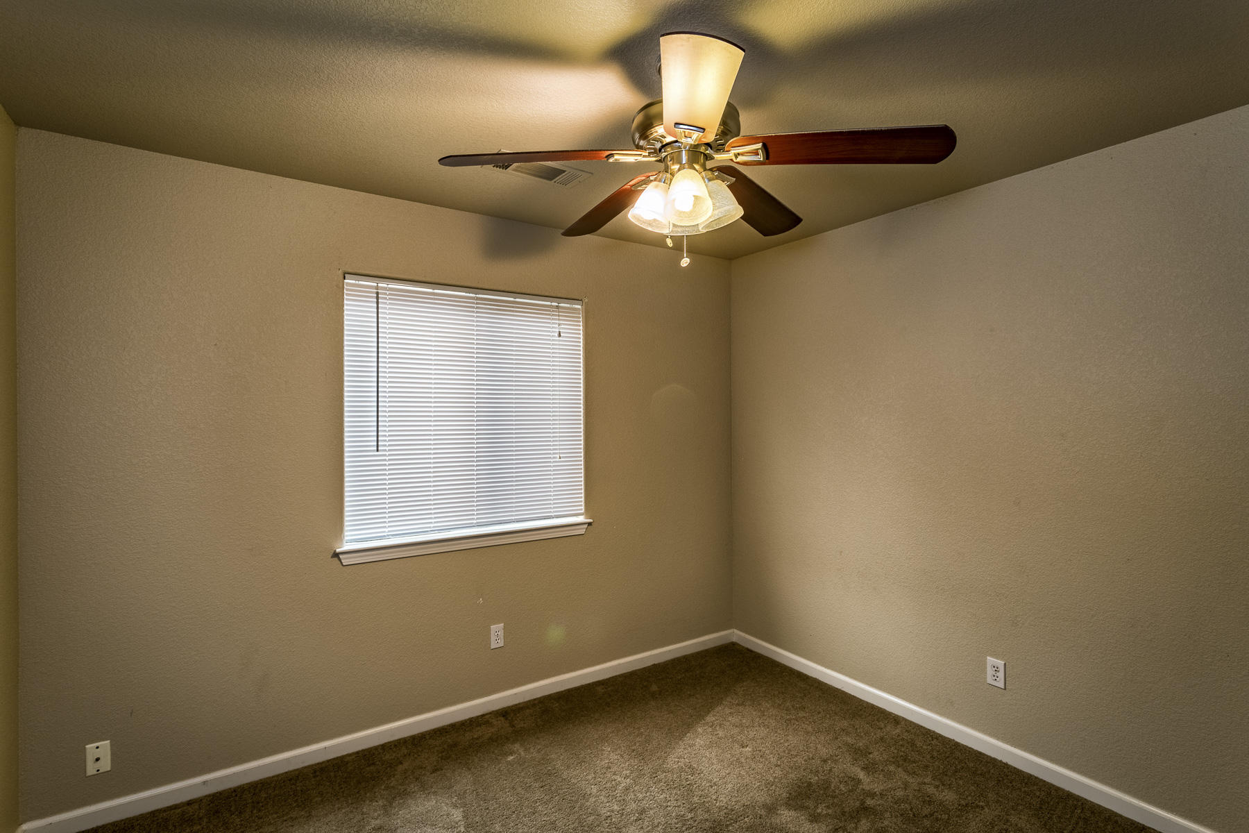 3339 Lawrence Road Redding, CA 96002 - Photo 11 of 18 an empty room with a window and a fan