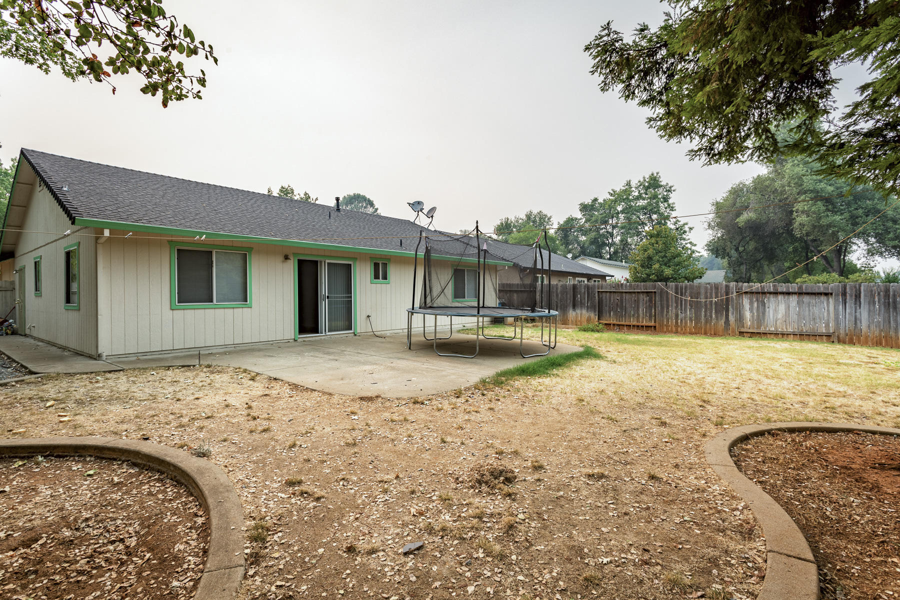 3339 Lawrence Road Redding, CA 96002 - Photo 15 of 18 a view of a house with backyard and sitting area