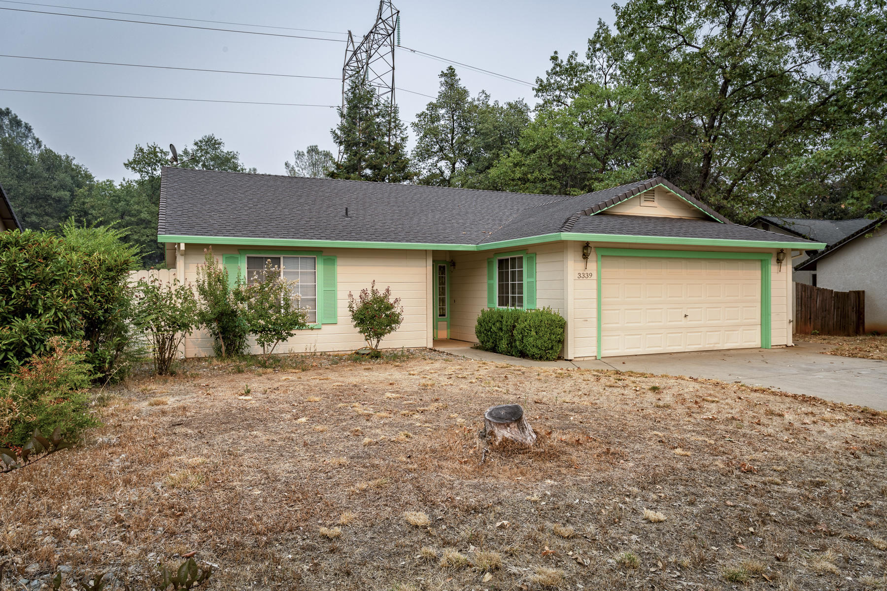3339 Lawrence Road Redding, CA 96002 - Photo 16 of 18 a front view of a house with a garden and yard