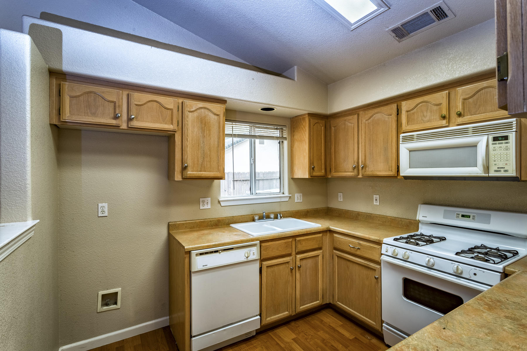 3339 Lawrence Road Redding, CA 96002 - Photo 5 of 18 a kitchen with a sink stove top oven and cabinets