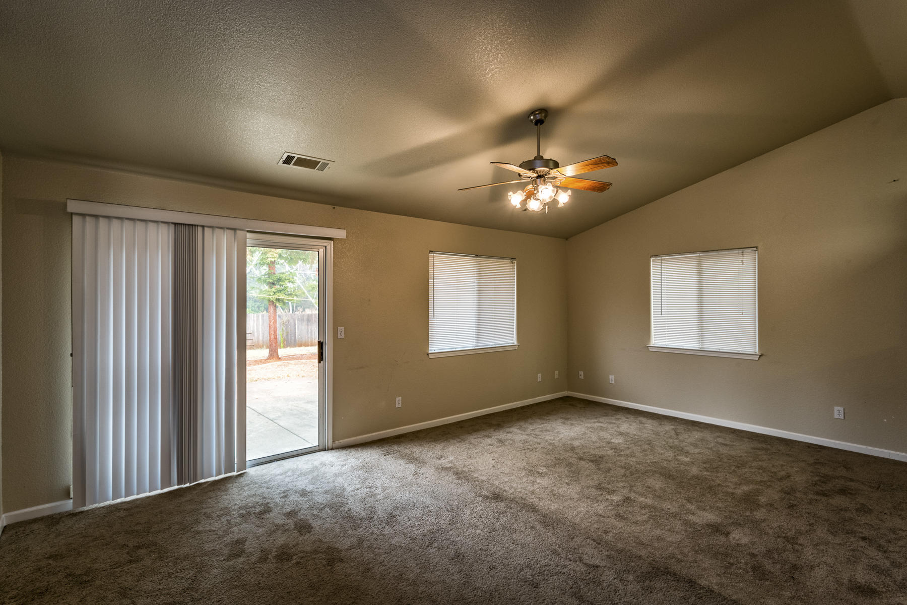 3339 Lawrence Road Redding, CA 96002 - Photo 7 of 18 an empty room with windows and fan