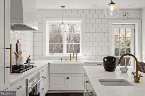 a spacious bathroom with a double vanity sink a mirror a bathtub and window