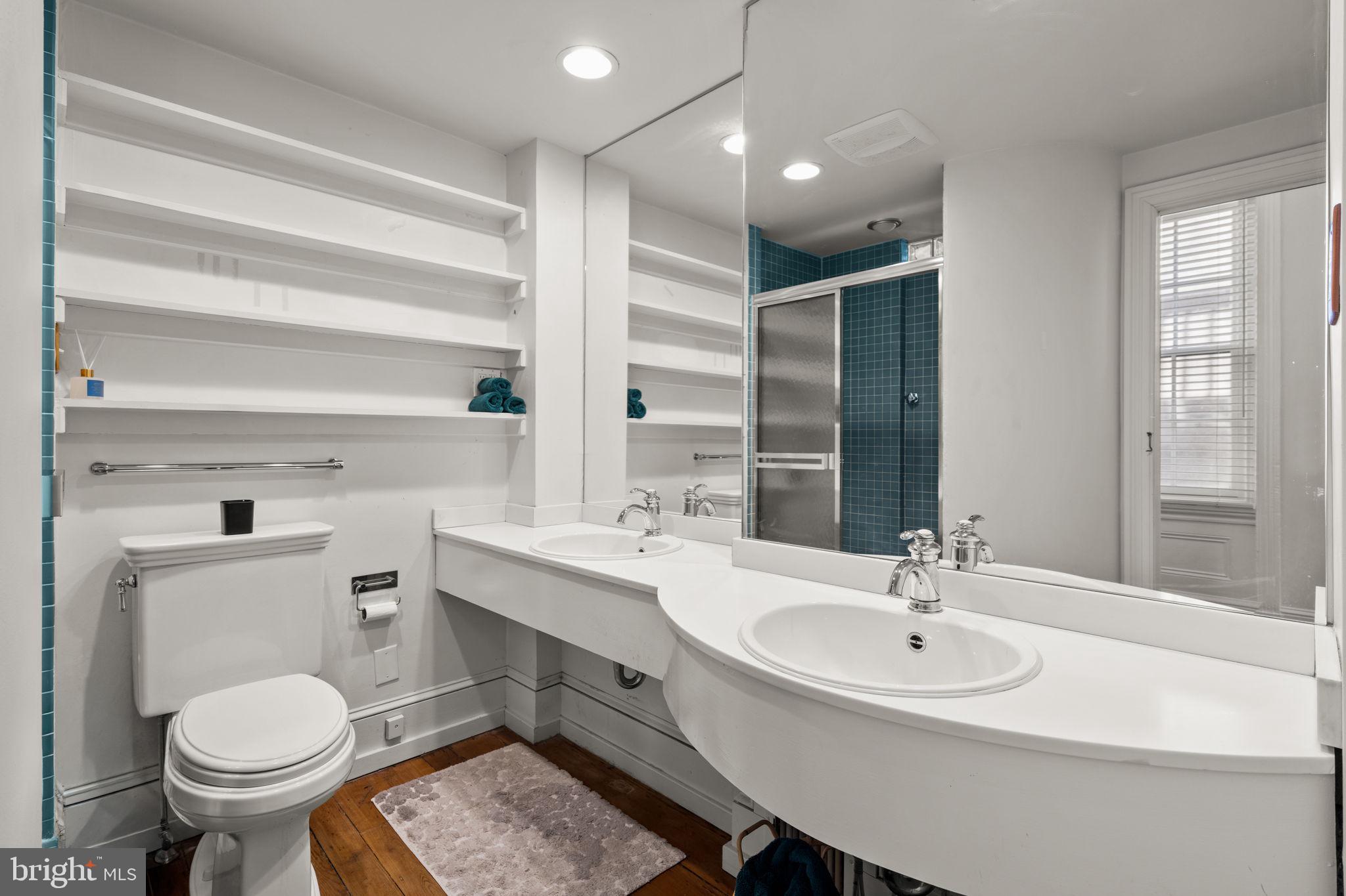 604 Spruce Street Philadelphia, PA 19106 - Photo 23 of 69 a bathroom with a sink toilet a mirror and shower