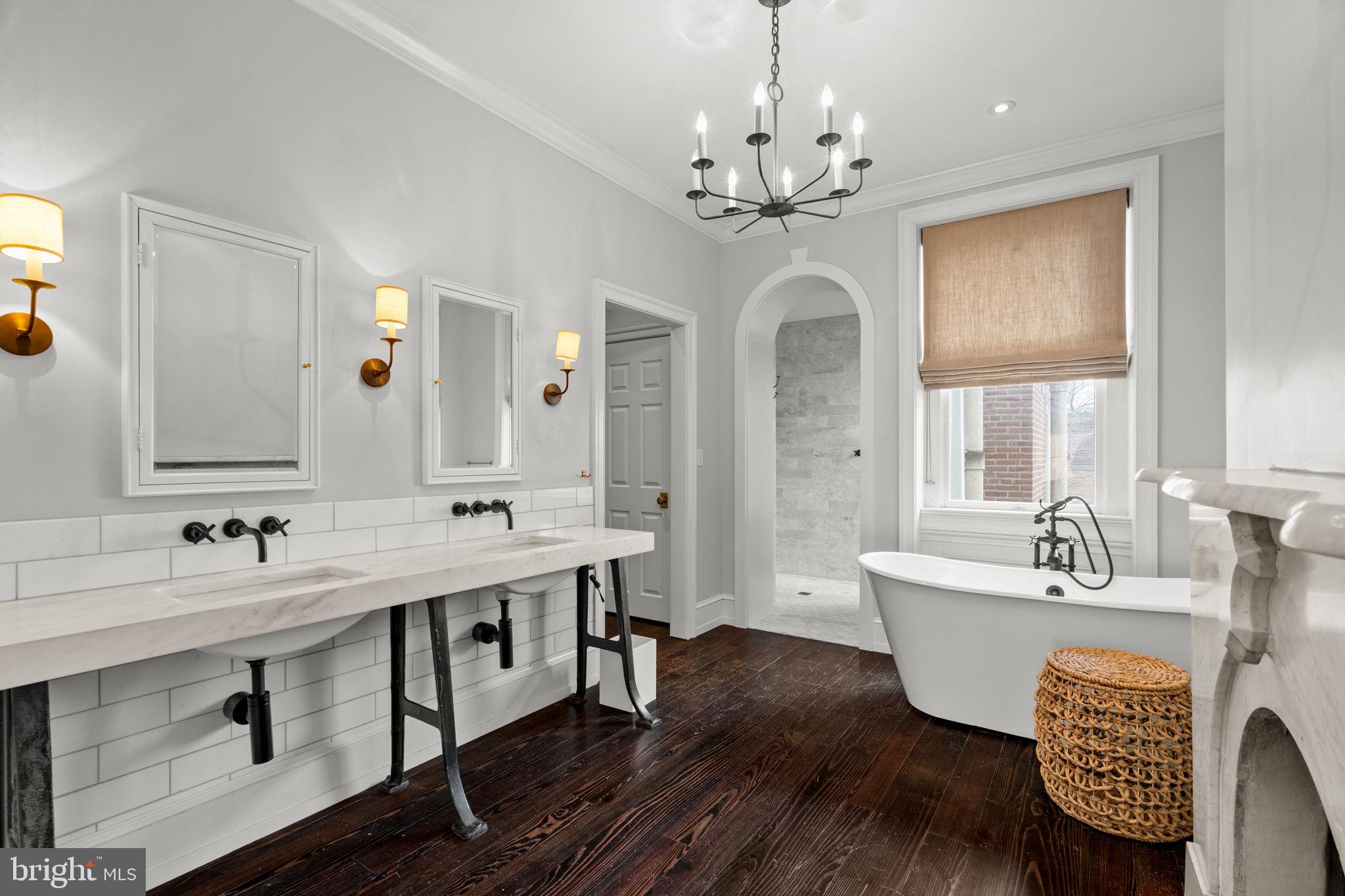 604 Spruce Street Philadelphia, PA 19106 - Photo 26 of 69 a spacious bathroom with a double vanity sink a mirror a bathtub and window