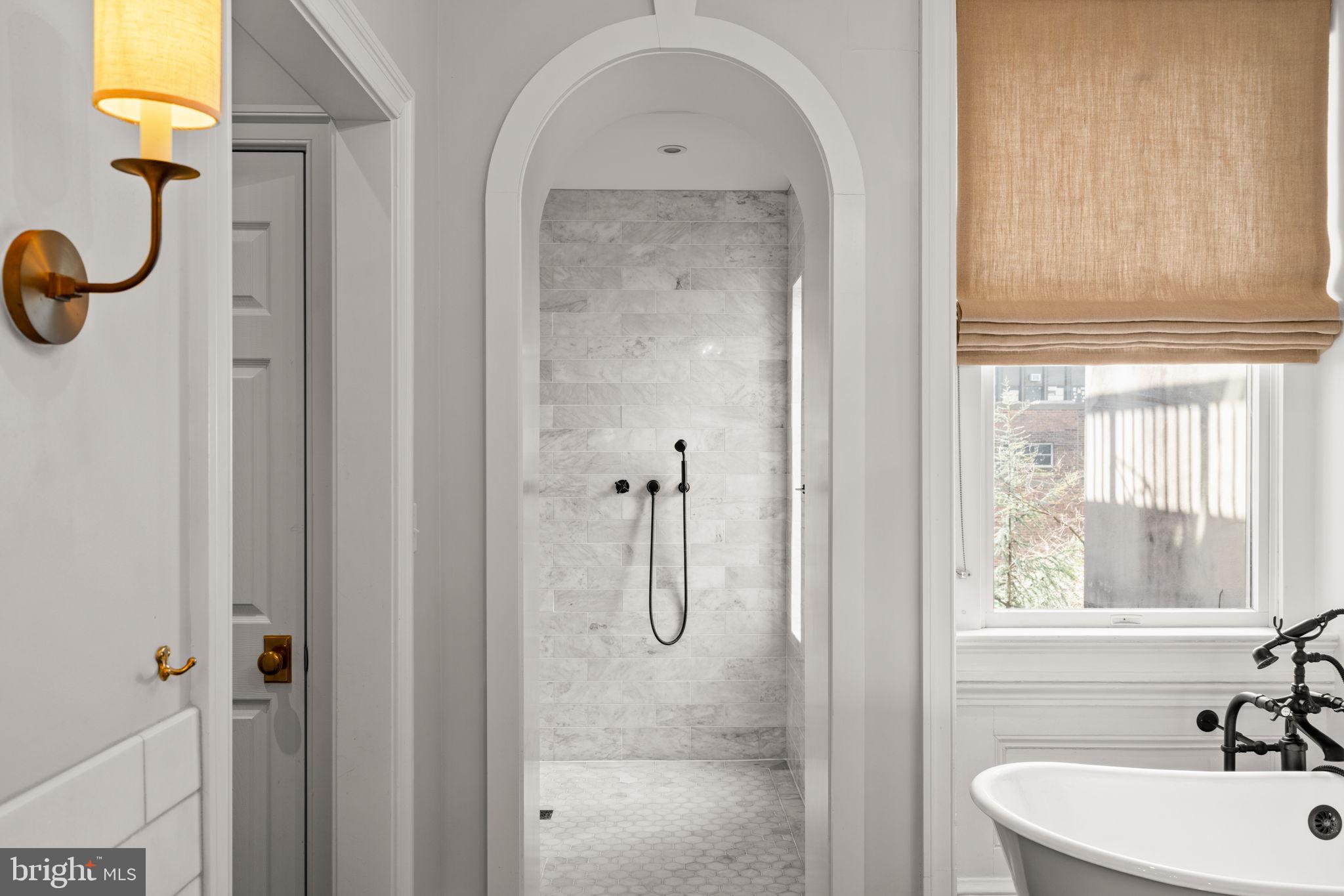 604 Spruce Street Philadelphia, PA 19106 - Photo 28 of 69 a bathroom with a granite countertop shower a sink and a window