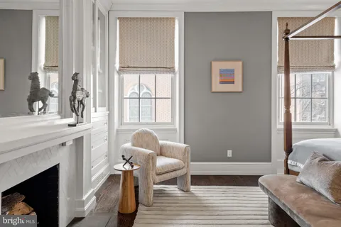 a bedroom with a bed a fireplace and a couch