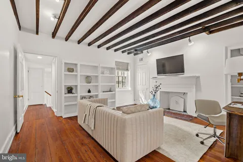 a view of a patio with couches chairs and wooden floor