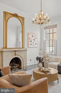 a living room with furniture fireplace and window