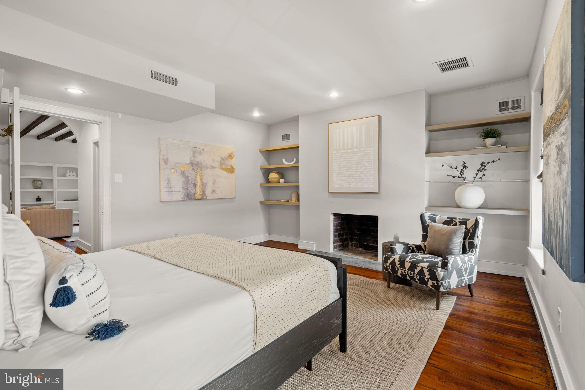 604 Spruce Street Philadelphia, PA 19106 - Photo 51 of 69 a bedroom with a bed a fireplace and a couch