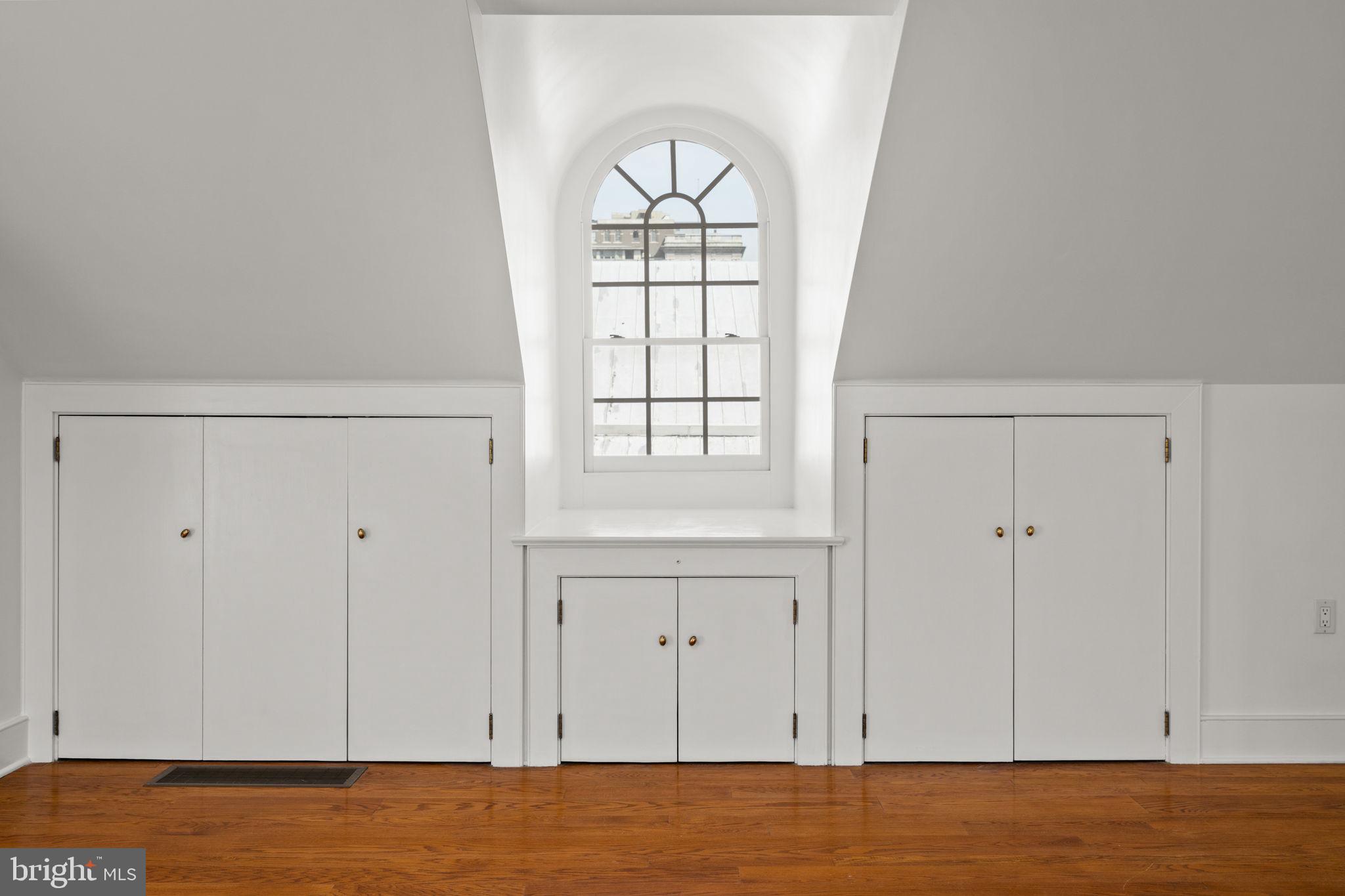 604 Spruce Street Philadelphia, PA 19106 - Photo 54 of 69 a view of an empty room with window and wooden floor