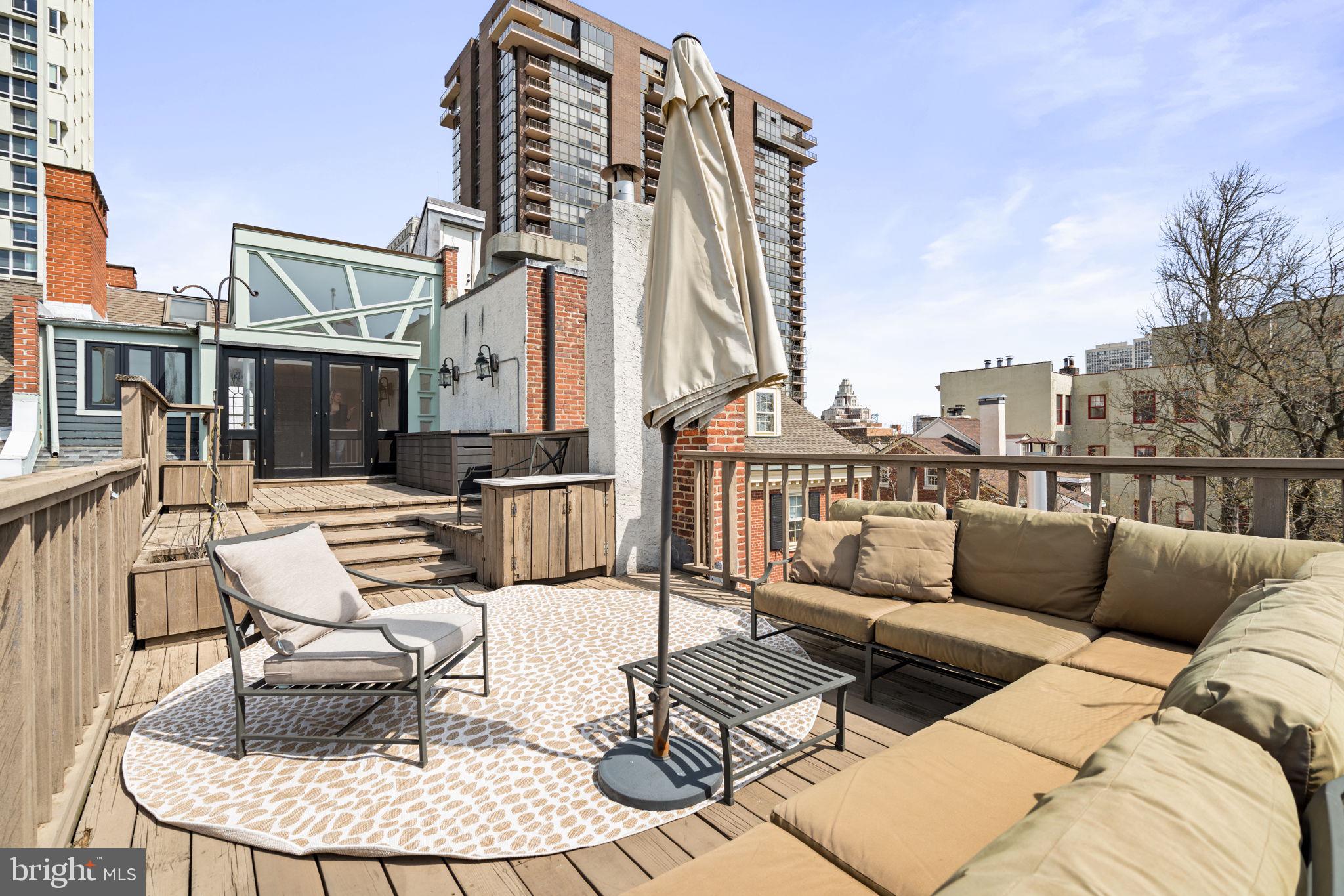604 Spruce Street Philadelphia, PA 19106 - Photo 62 of 69 a view of a patio with couches chairs and wooden floor